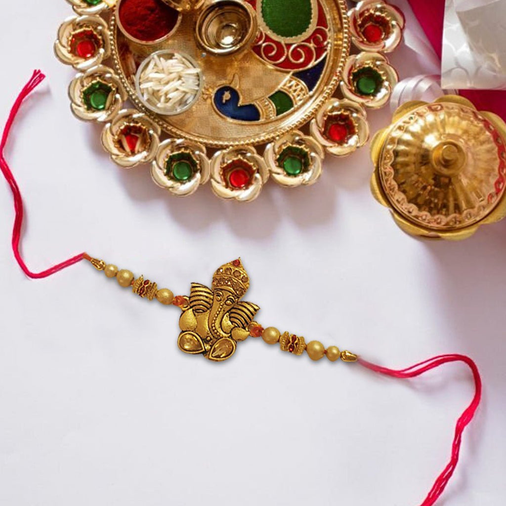 Ganesha Rakhi With Pearls Golden Finish - Singh Cart